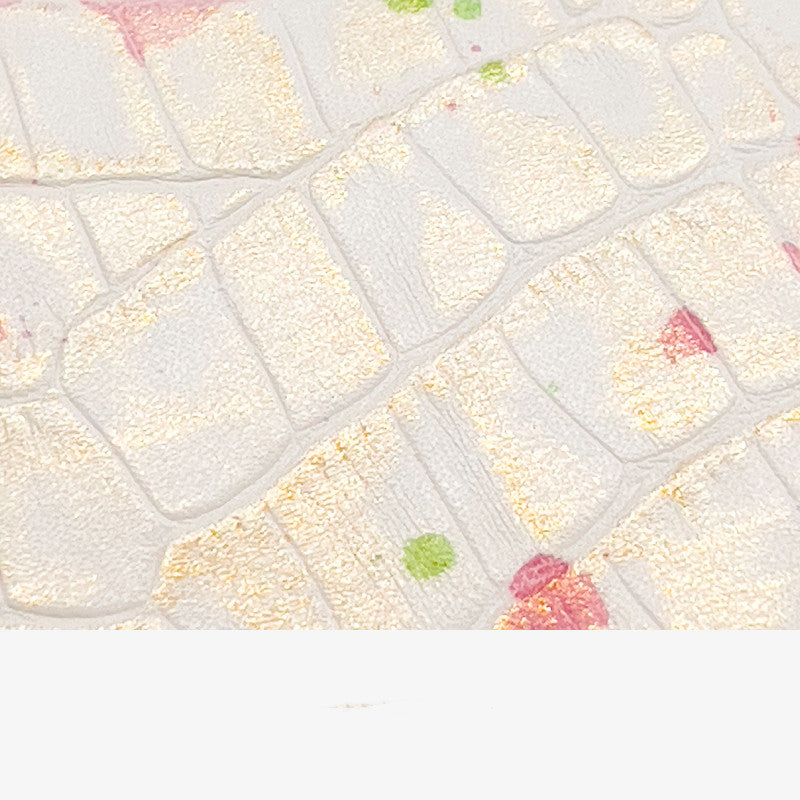 Close-up of a quilt with a diamond pattern and colorful accents.