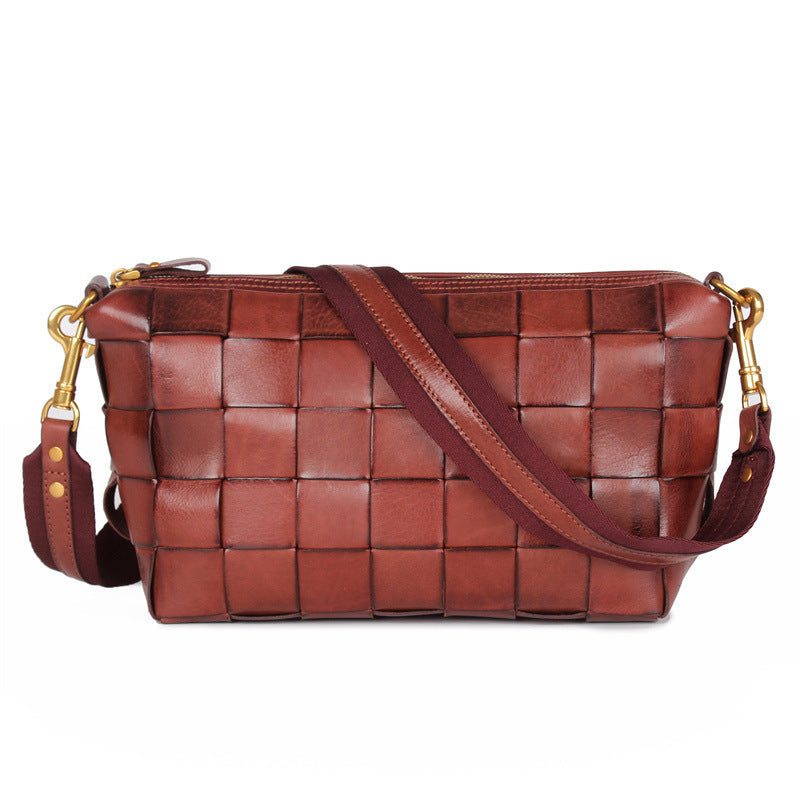 Brown woven handbag with gold accents on a white background