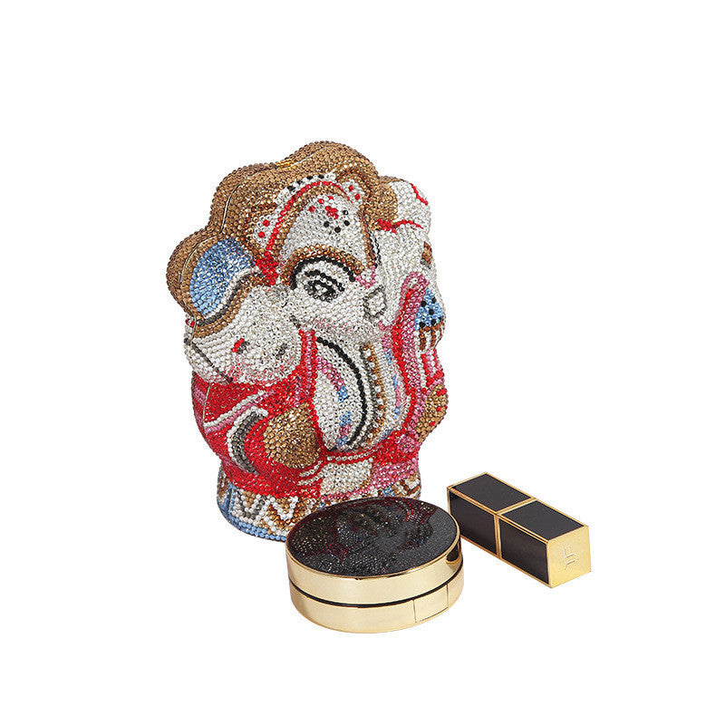 Decorative item with face design next to a lipstick on a white background