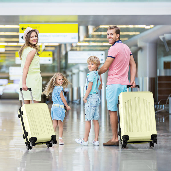 Family of four with luggage at an airport