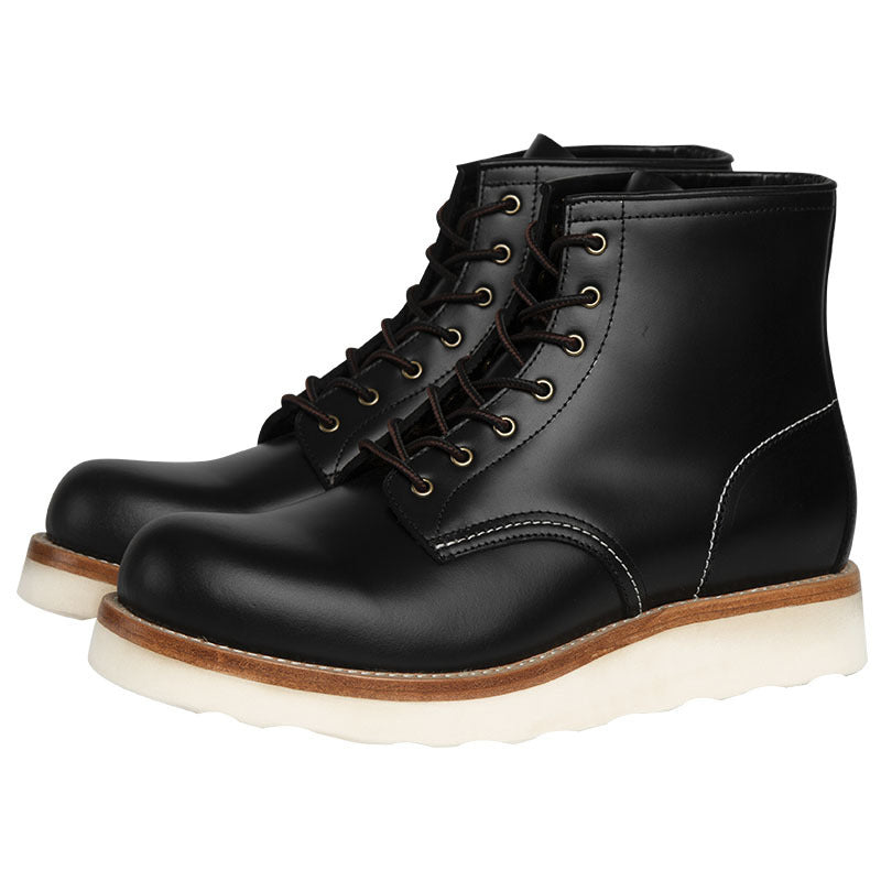 Black leather boots with white soles on a white background