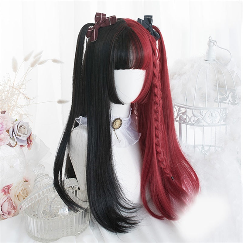 Mannequin head with two-tone black and red wig on a decorative background