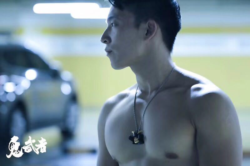 Man with a necklace in a parking garage