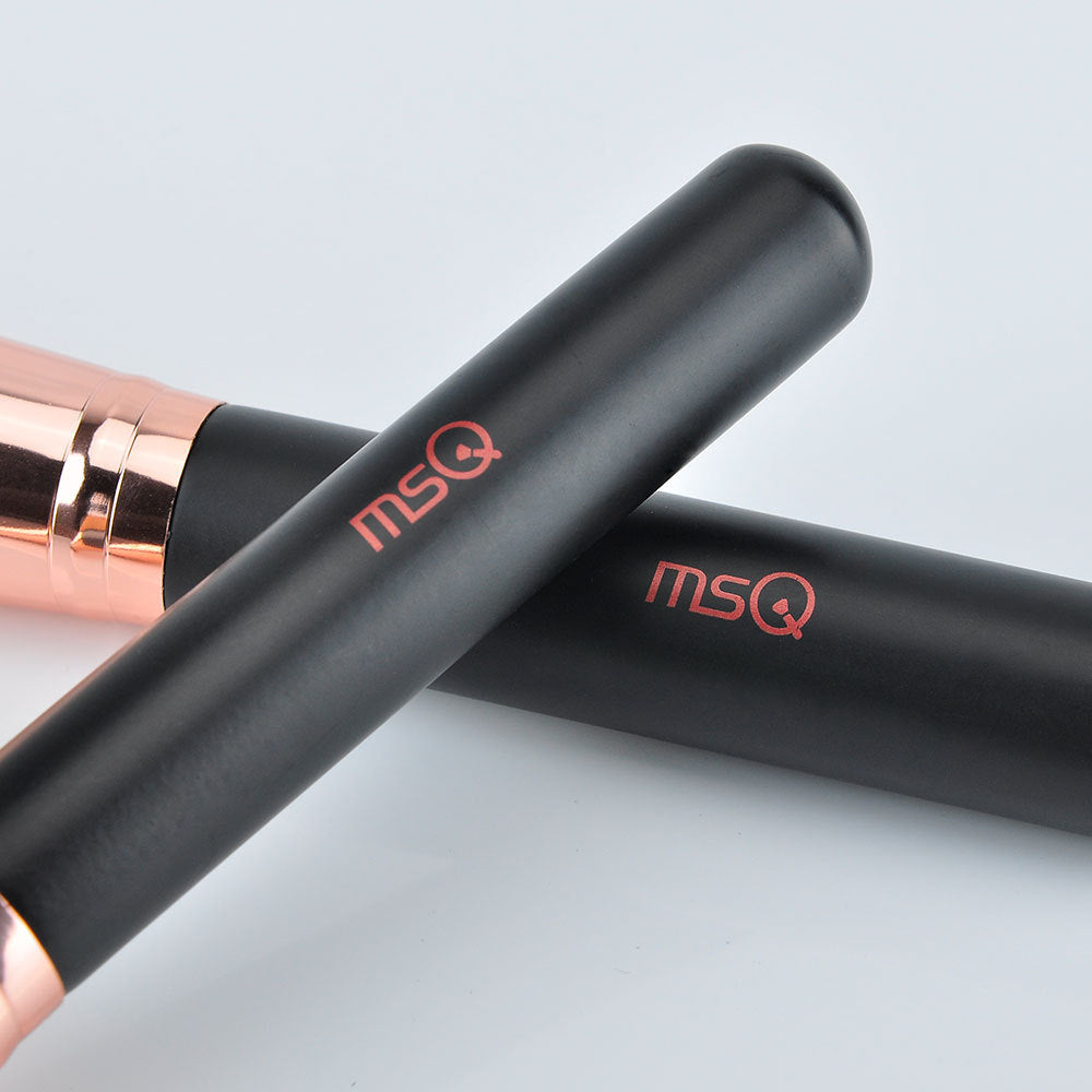 Black and rose gold makeup products with 'msq' logo on a light gray background