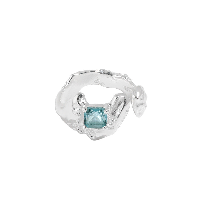 Silver ring with a blue gemstone on a white background