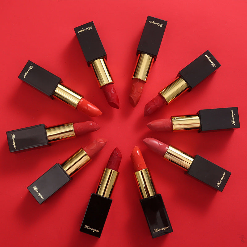 Lipsticks arranged in a circular pattern on a red background
