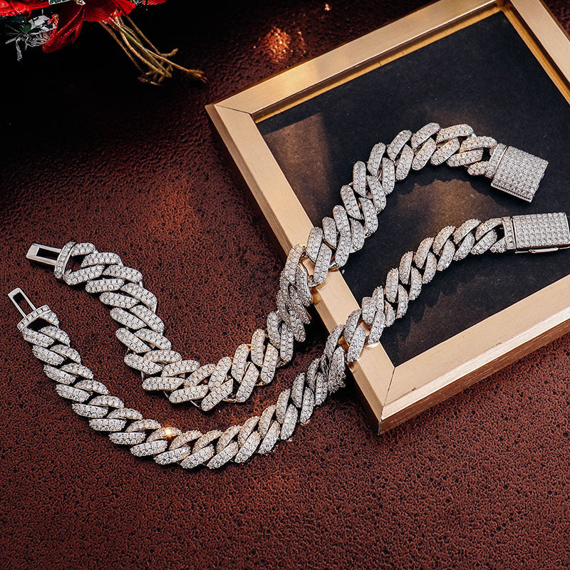 Silver chain necklace on a dark textured surface with a gold frame.