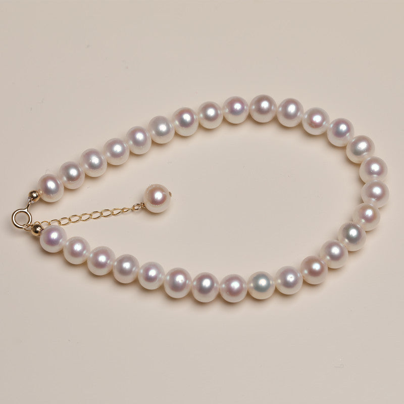 Pearl necklace on a beige background