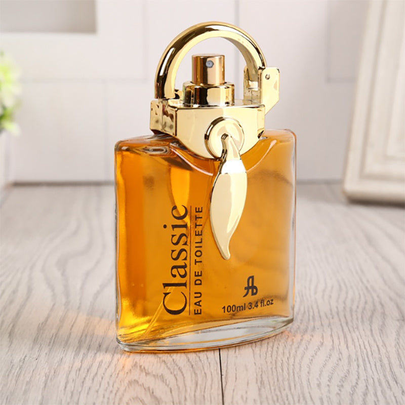 Perfume bottle with gold cap on a wooden surface