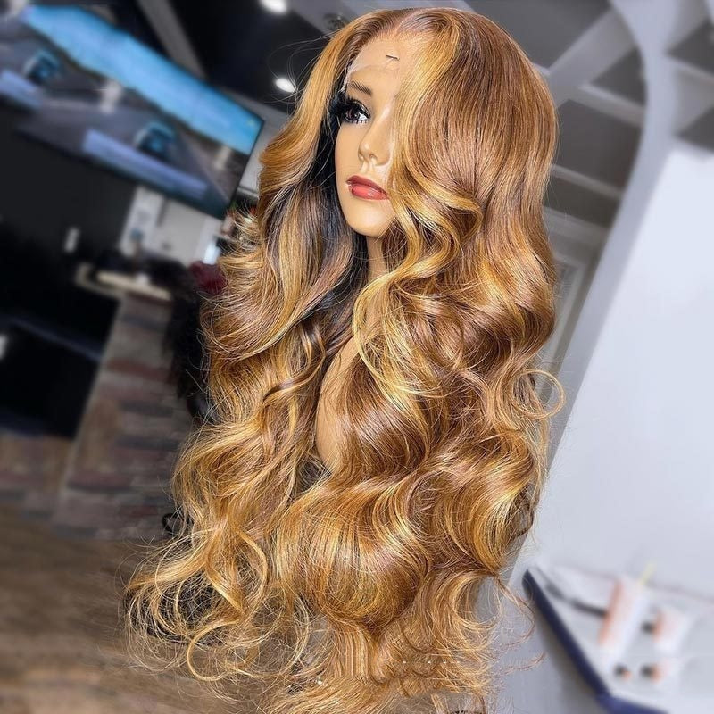 Blonde wavy wig on a mannequin head with a blurred indoor background