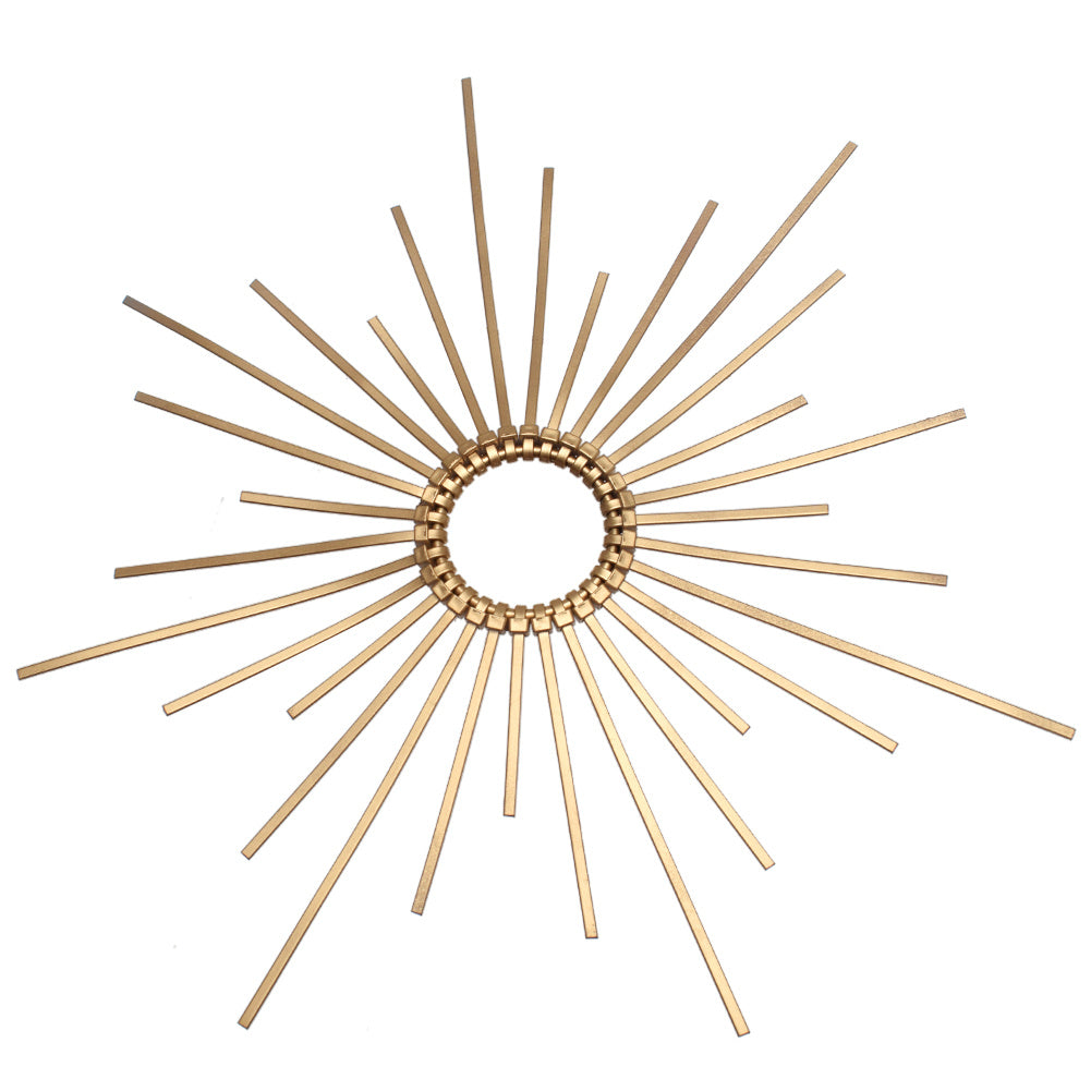 Decorative wall mirror with sunburst design on a white background