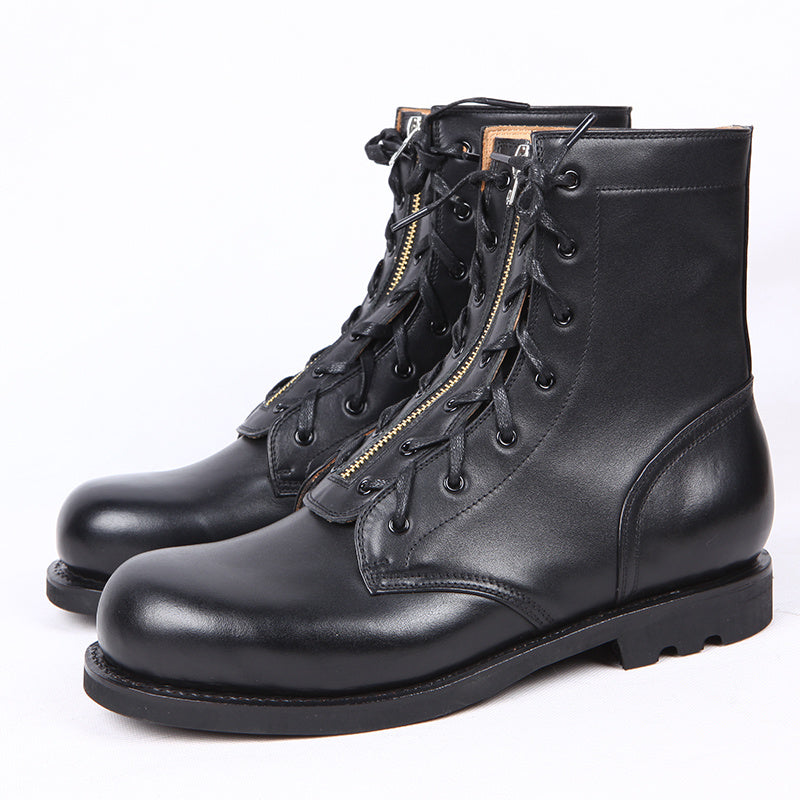 Pair of black leather boots with laces and a zipper on a white background