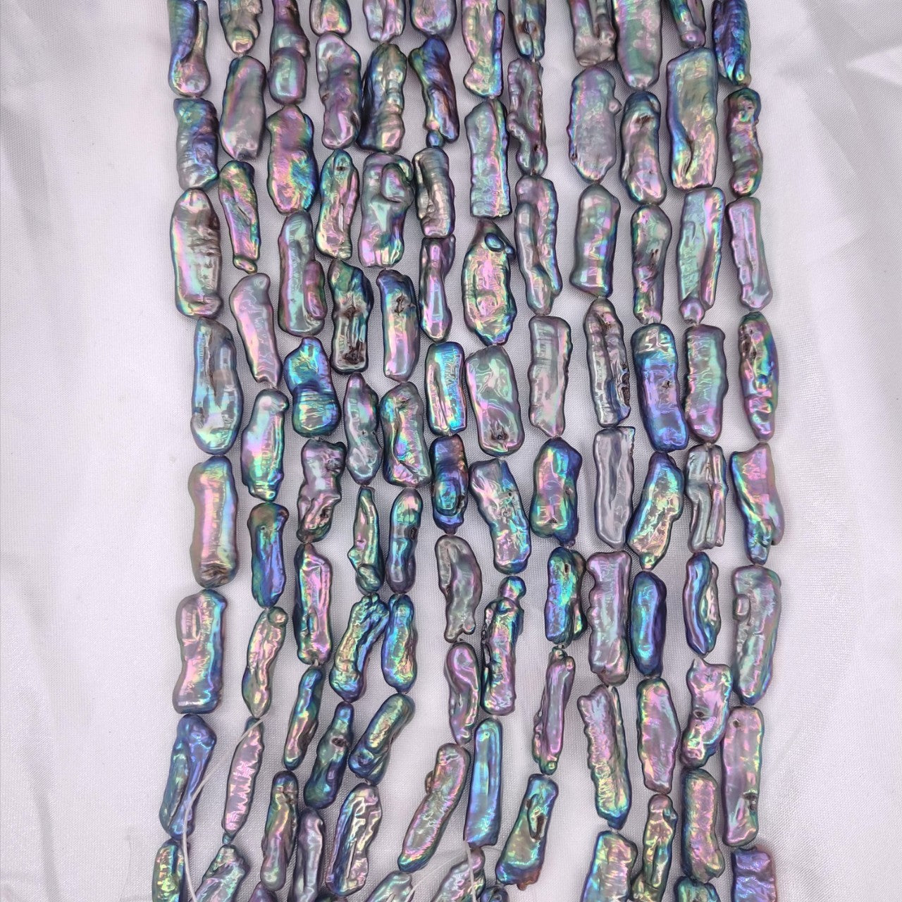 Multicolored iridescent beads on a white background