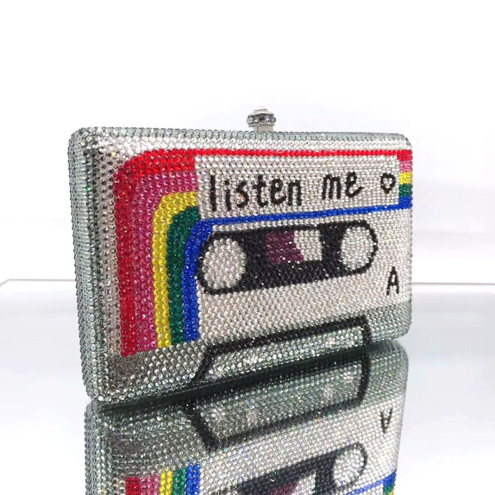 Sparkly clutch bag with a cassette tape design and 'listen me' text on a white background