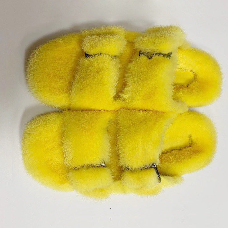 Pair of yellow fluffy slippers on a white background