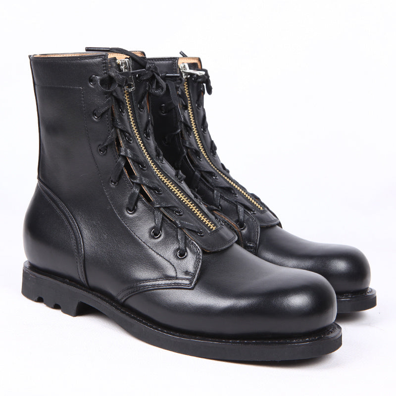 Pair of black leather boots with zippers on a white background