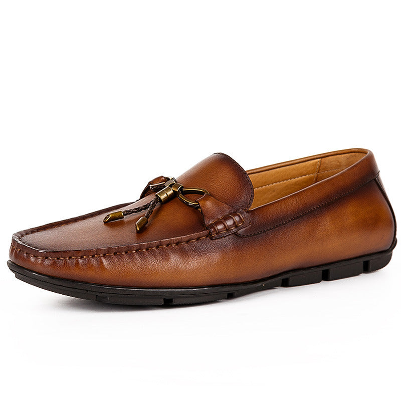 Brown leather loafer with a decorative bow on a white background