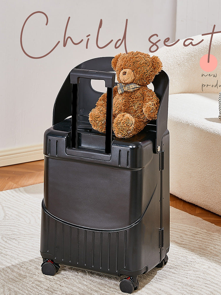 Black child seat with a teddy bear on a carpeted floor.
