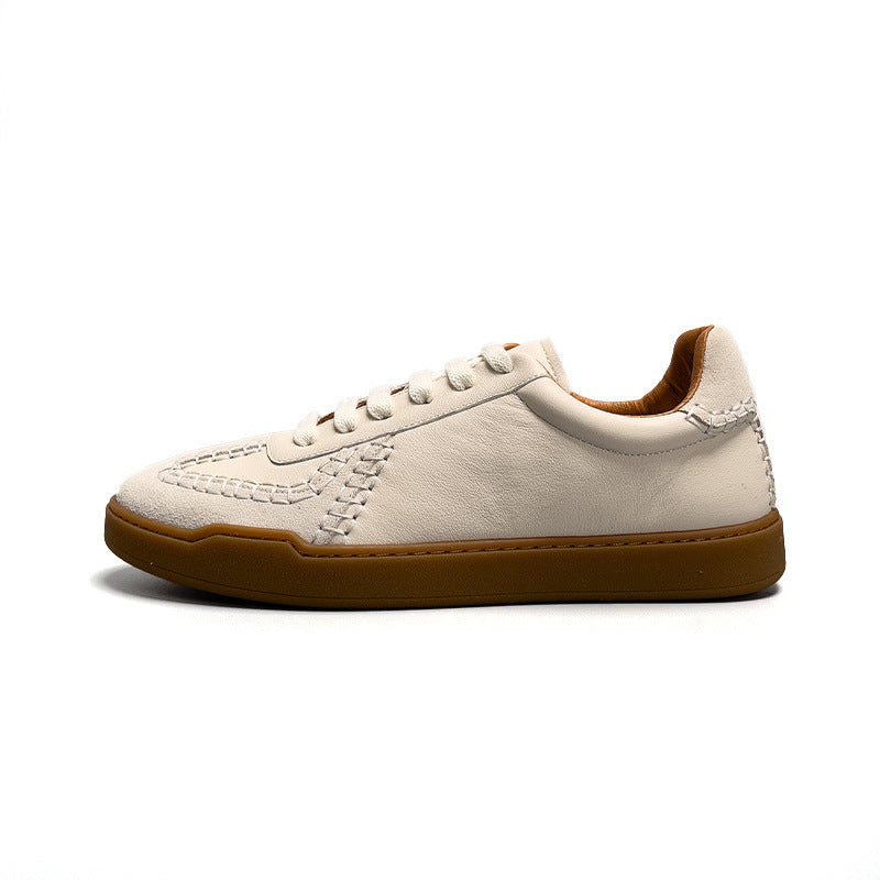 White sneaker with brown sole on a white background