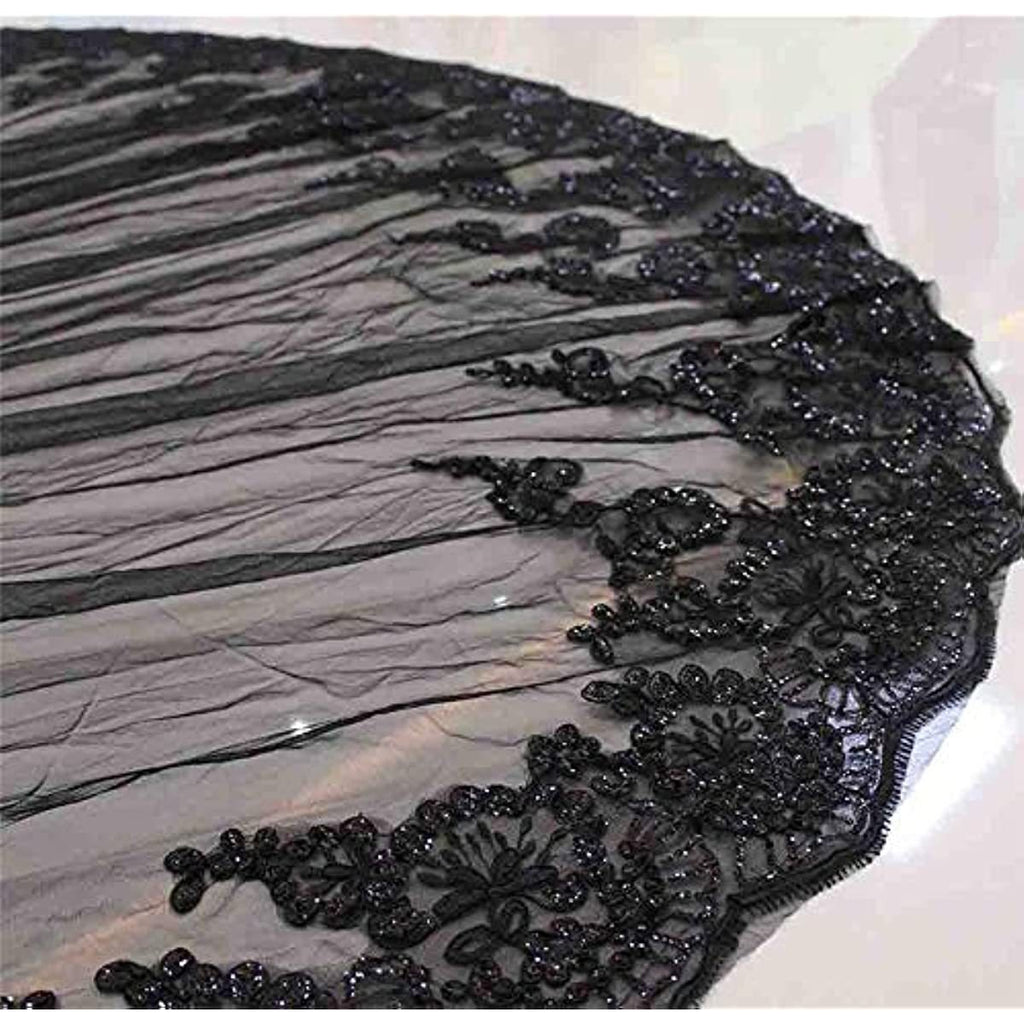 Black embroidered fabric with intricate patterns on a white background