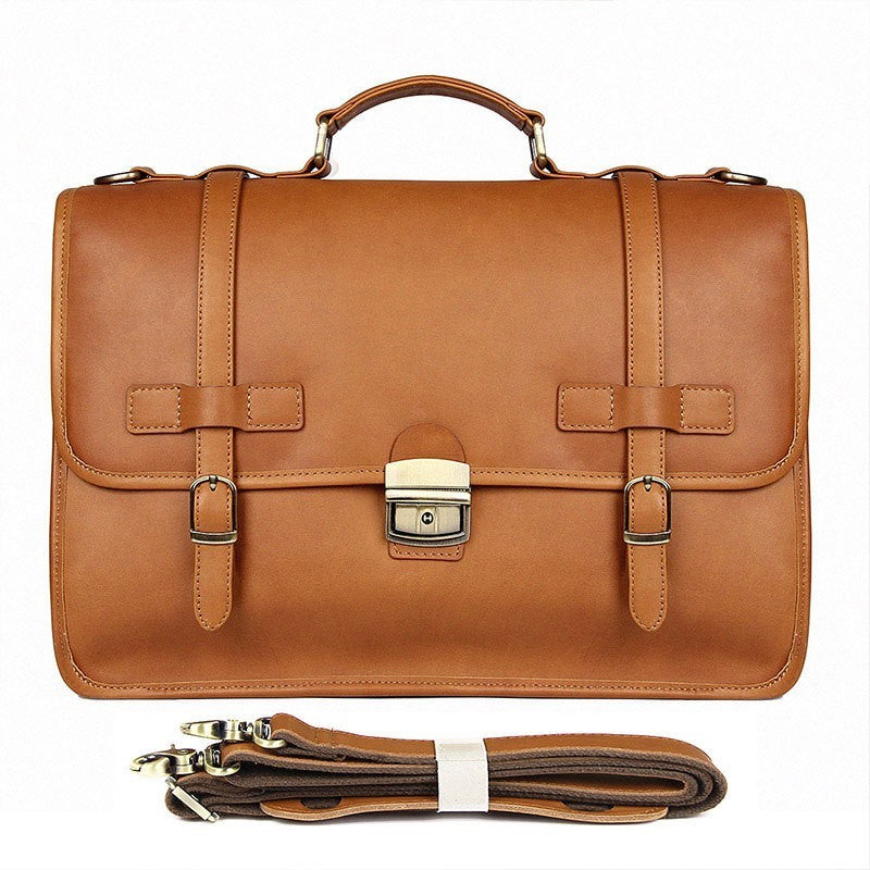Brown leather briefcase with strap on a white background