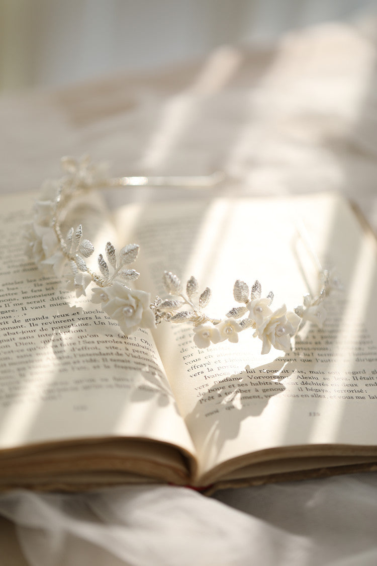 Two decorative tiaras on an open book with soft lighting