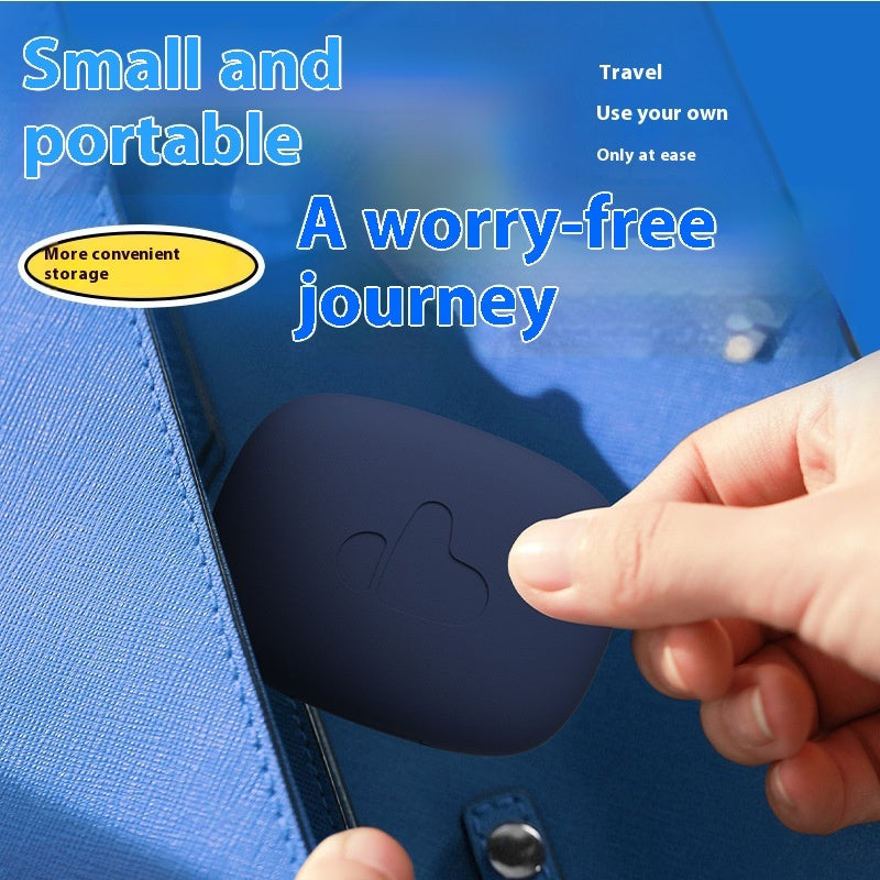 Hand placing a small black device into a blue suitcase with text about portability and travel convenience.