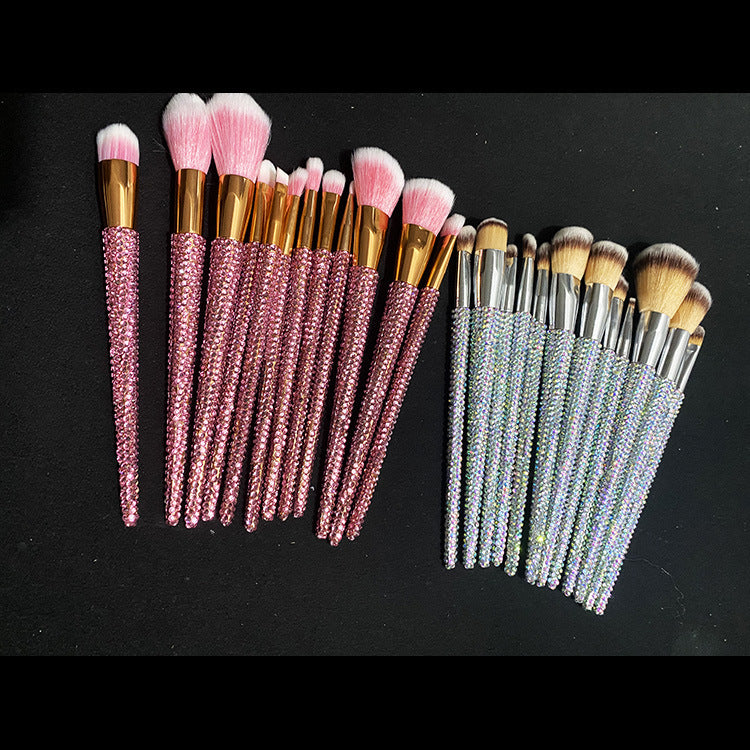 Makeup brushes with pink and silver handles on a black background