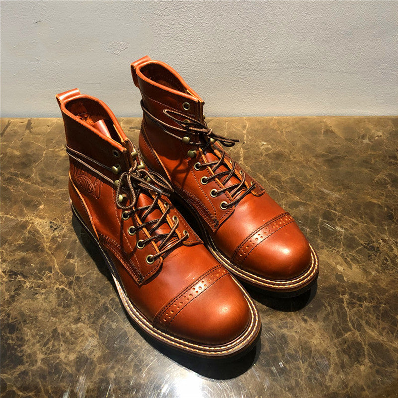 Pair of brown leather boots on a textured surface