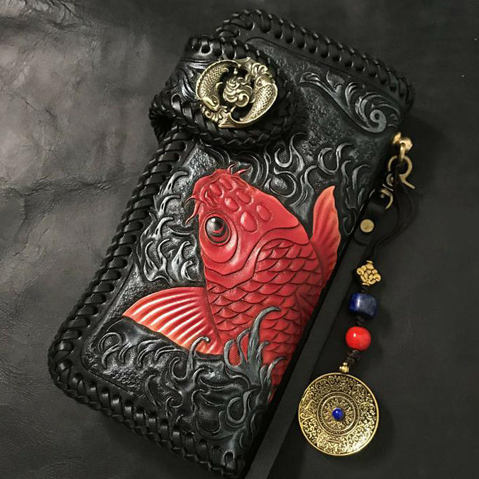 Decorative pouch with red fish design and gold accents on a dark background