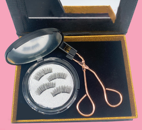 Eyelash extension set with tweezers in a black and gold box on a pink background