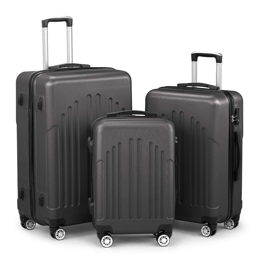 Set of three black suitcases of different sizes on a white background