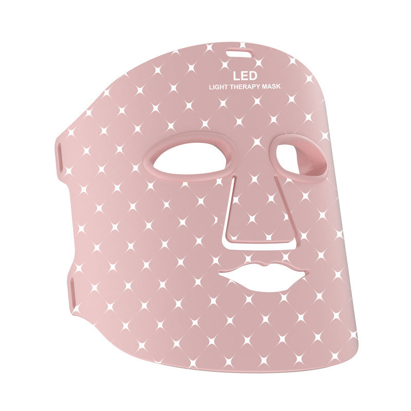 Pink LED light therapy mask with star pattern on a white background