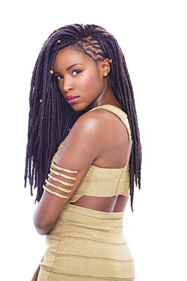 Woman with styled hair wearing a gold dress on a white background