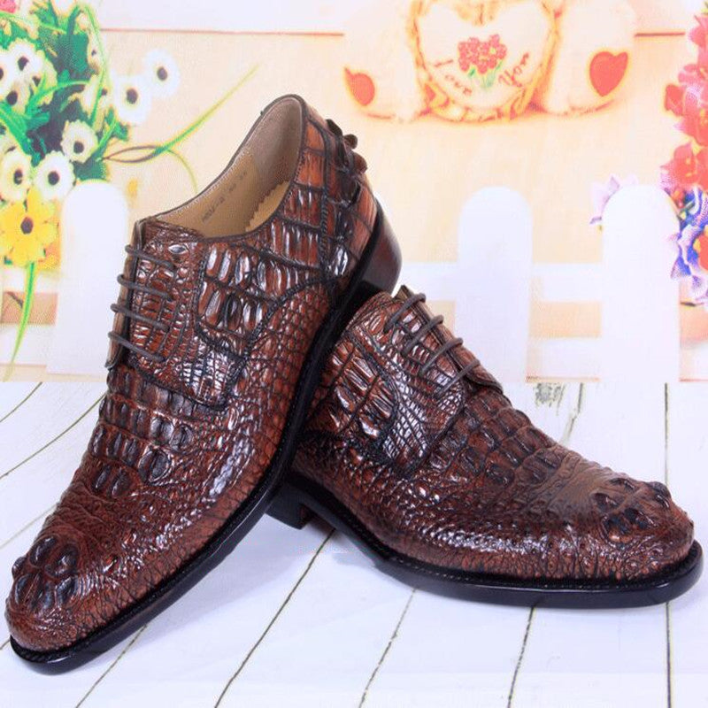 Brown crocodile-patterned shoes on a light wooden floor with a floral background