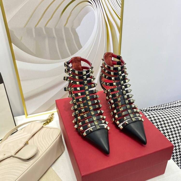 Studded high-heeled shoes on a red box with a decorative background