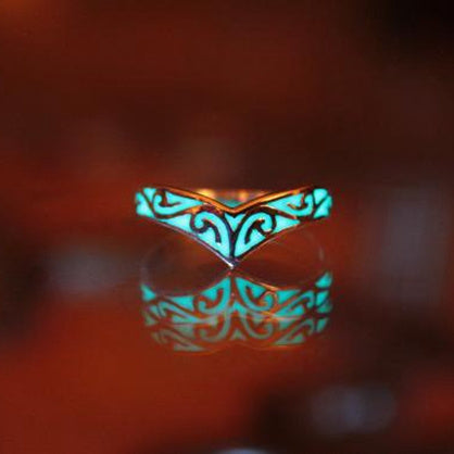 Glowing ring with intricate design on a dark background