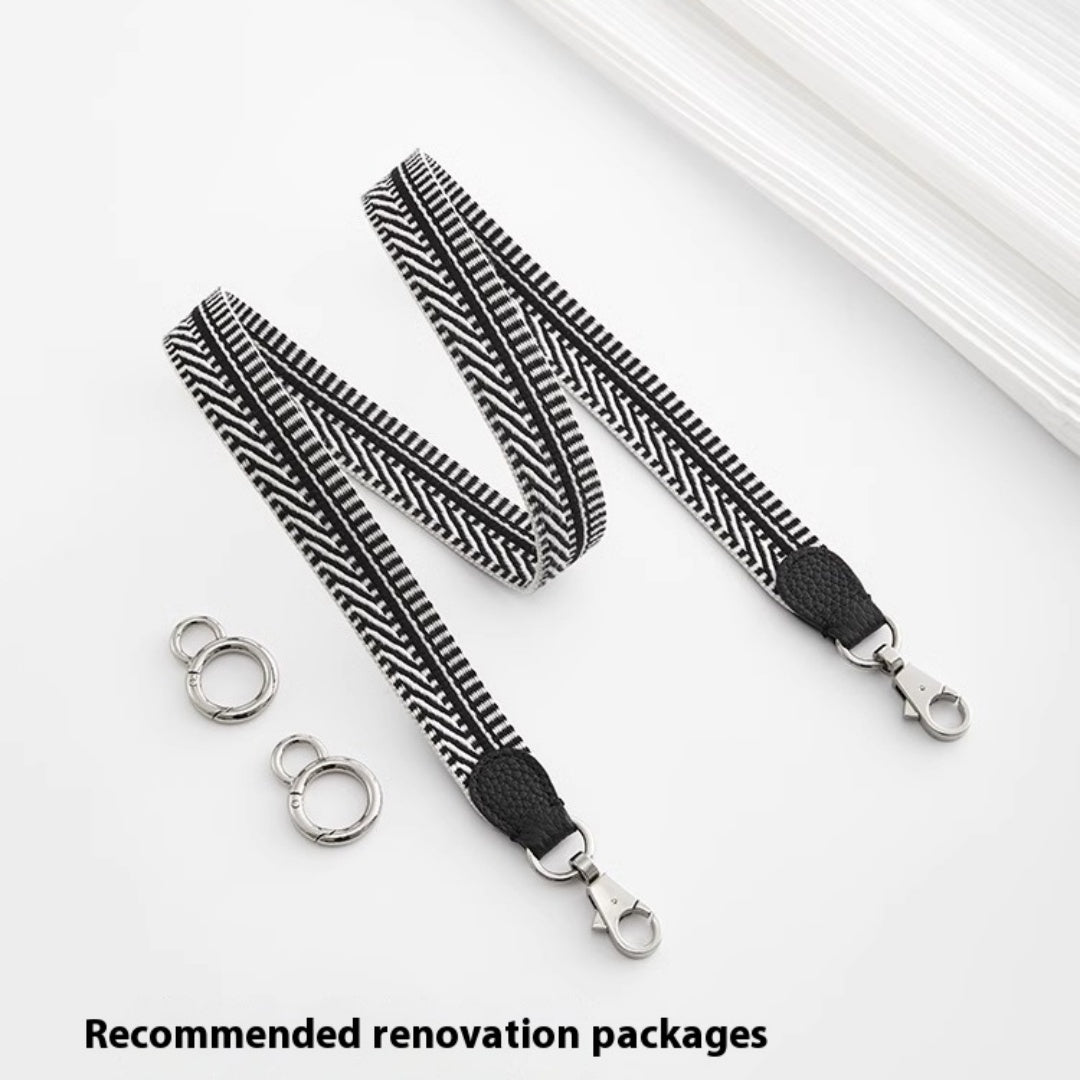 Black and white patterned lanyard with metal hooks on a light gray background