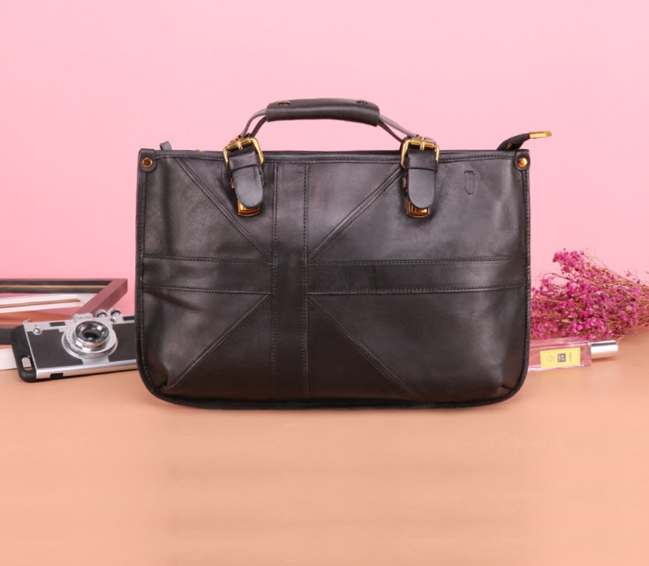 Brown leather handbag on a pink background with a camera and flowers.