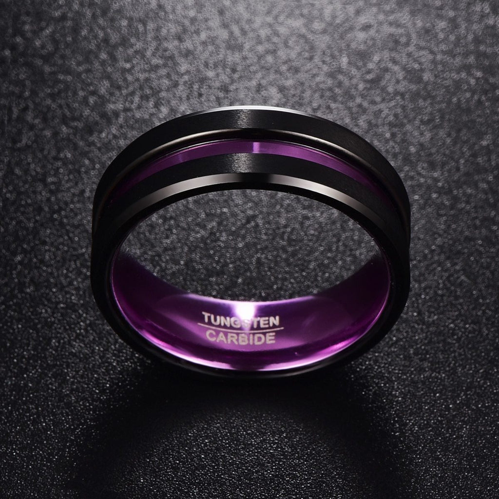 Black and purple tungsten carbide ring on a textured black background