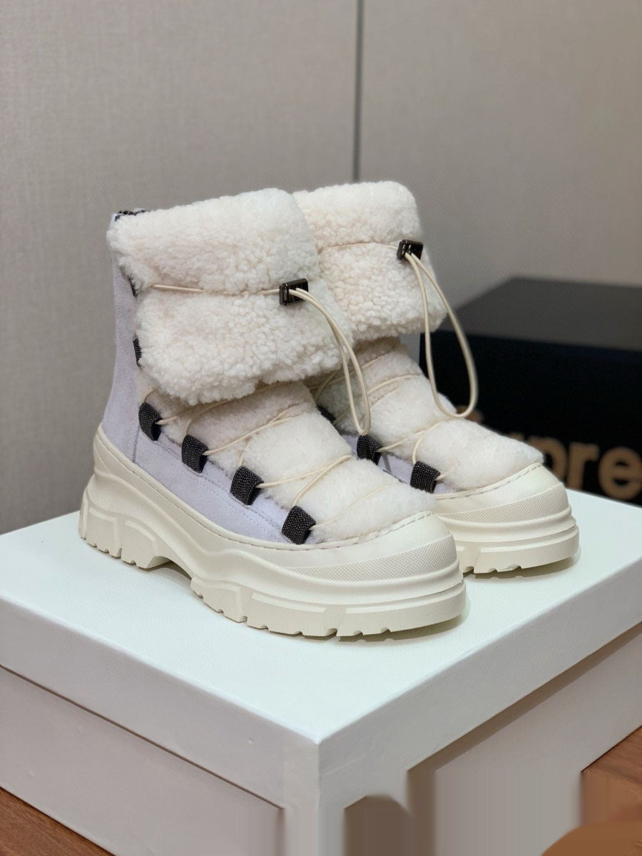 White winter boots with fluffy lining on a white surface