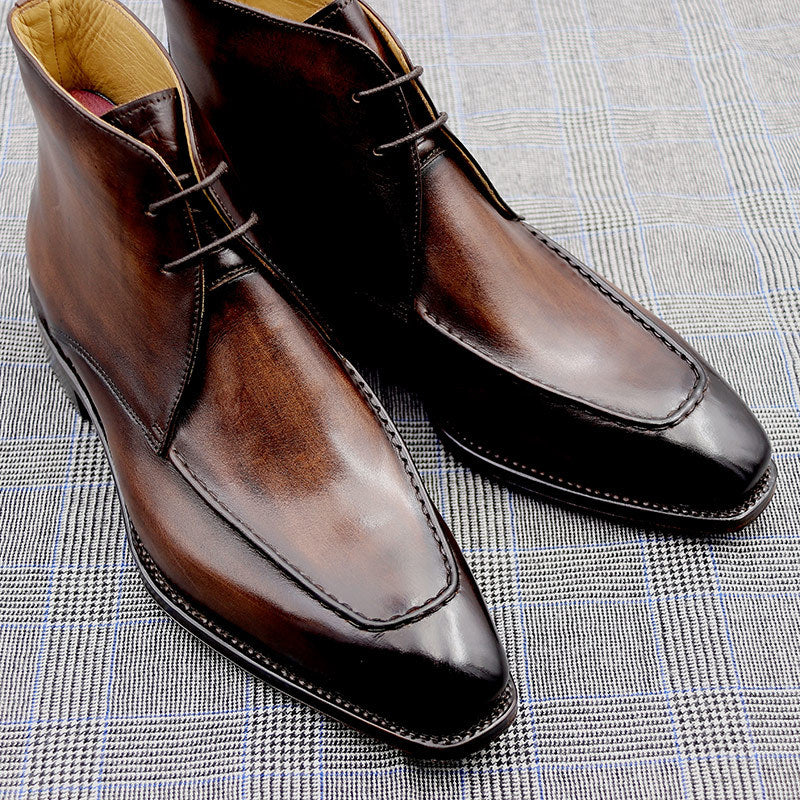 Pair of brown leather dress shoes on a textured surface