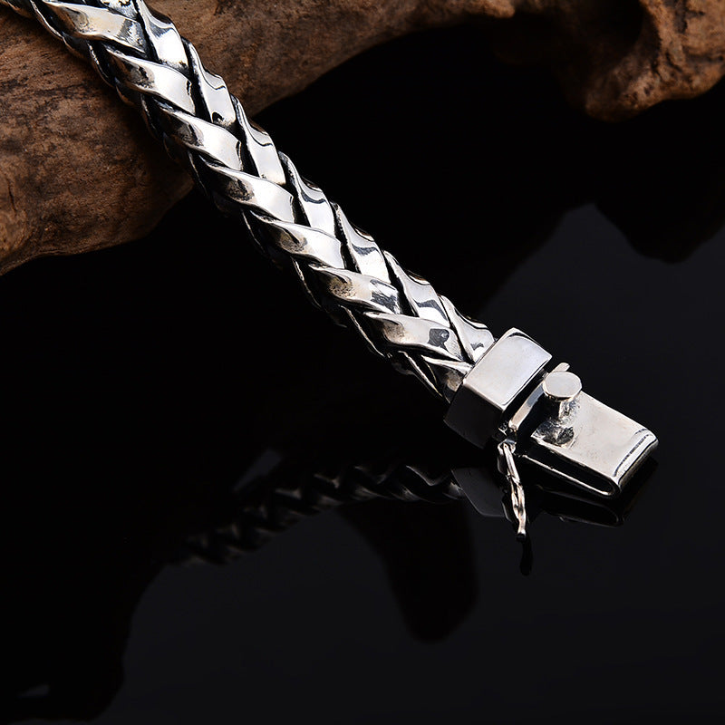 Silver braided bracelet on a dark background
