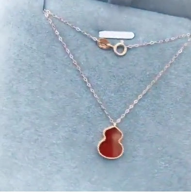 Necklace with a red pendant on a light blue background