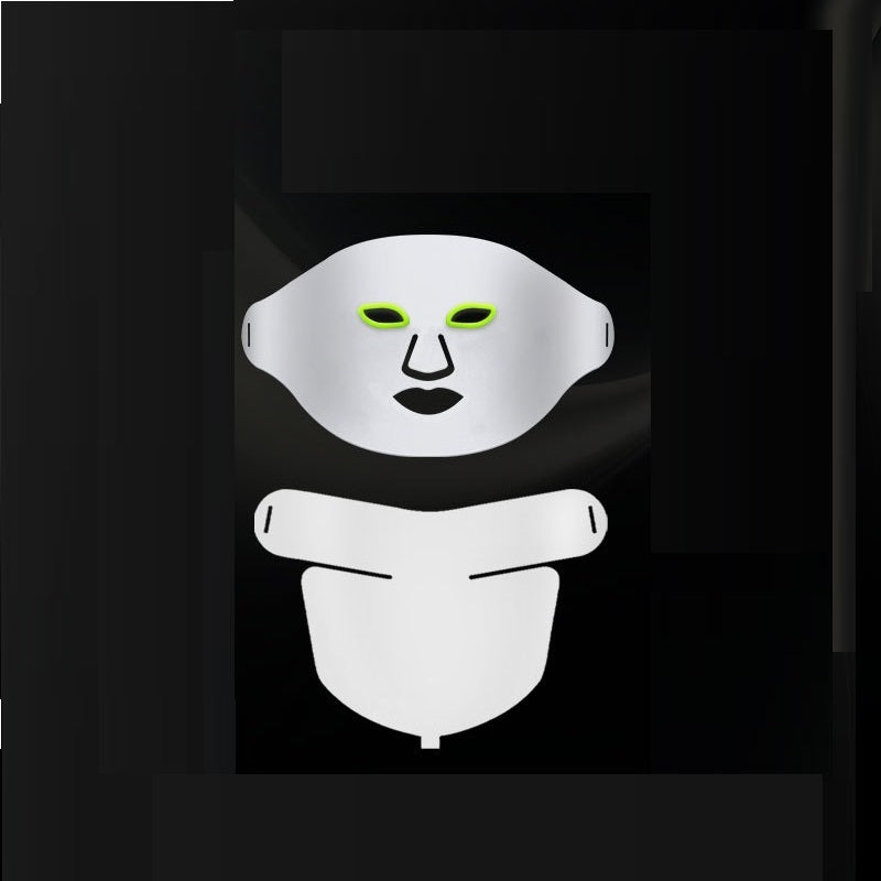 White face mask with green eye sockets on a black background