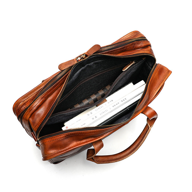 Brown leather bag with a black interior on a white background