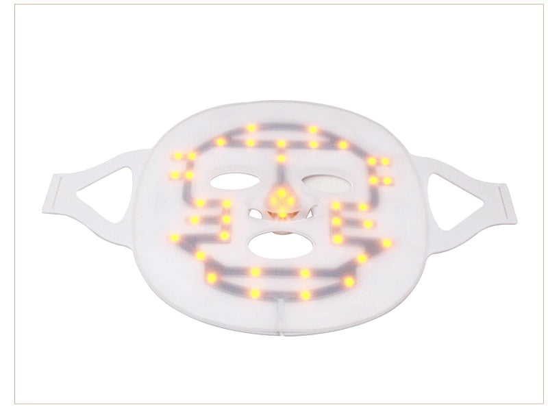 LED face mask with a smiley face design on a white background