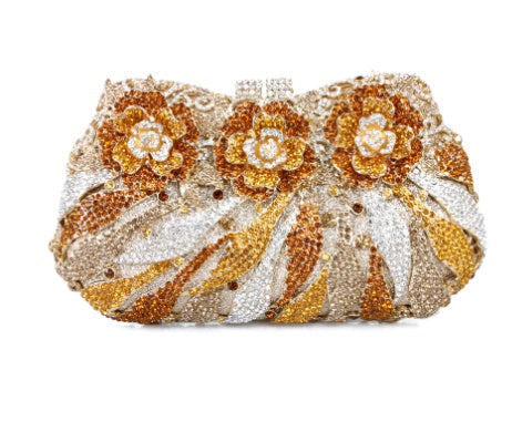 Decorative clutch bag with floral patterns and gold, silver, and orange colors on a white background