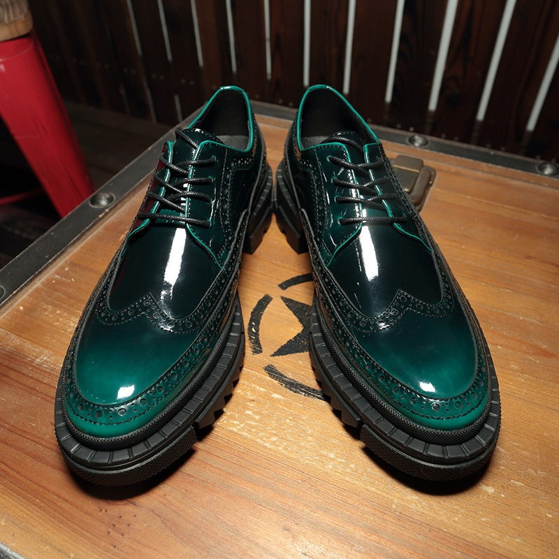 Pair of green leather shoes on a wooden surface with a blurred background