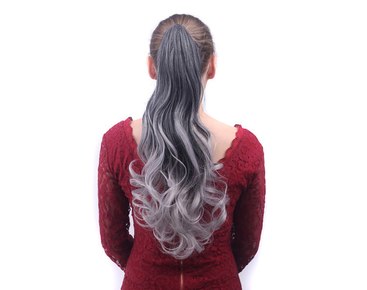 Person wearing a gray ponytail extension on a white background